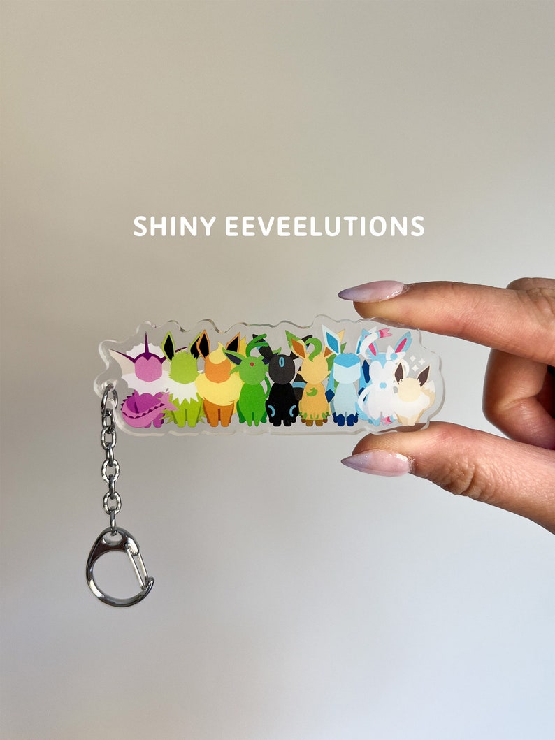 Shiny Eeveelutions clear acrylic keychain featuring shiny versions of the Eevee evolutions: Flareon, Jolteon, Vaporeon, Umbreon, Espeon, Leafeon, Glaceon, and Sylveon.