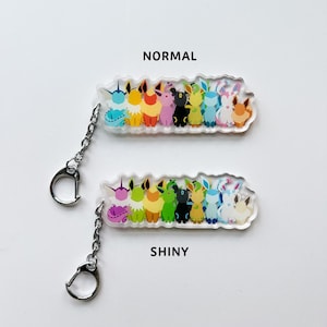 Eeveelution acrylic keychains, both normal and shiny Eevee options available. Featuring all the Eeveelutions: Flareon, Jolteon, Vaporeon, Umbreon, Espeon, Leafeon, Glaceon, and Sylveon with a metal clip on attachment.