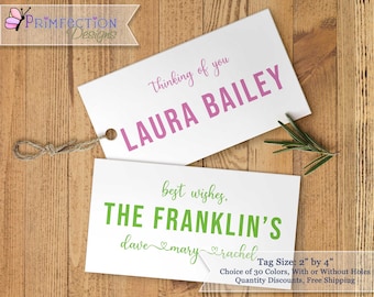May include: Two white gift tags with text. The top tag is pink and says "Thinking of you Laura Bailey". The bottom tag is green and says "Best wishes, The Franklin's dave &mary &rachel". The tags are 2 inches by 4 inches.