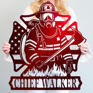 May include: A red metal sign featuring a firefighter in full gear, holding an axe, with an American flag design and the text "CHIEF WALKER." The sign is cut out with intricate details, including flames at the bottom.