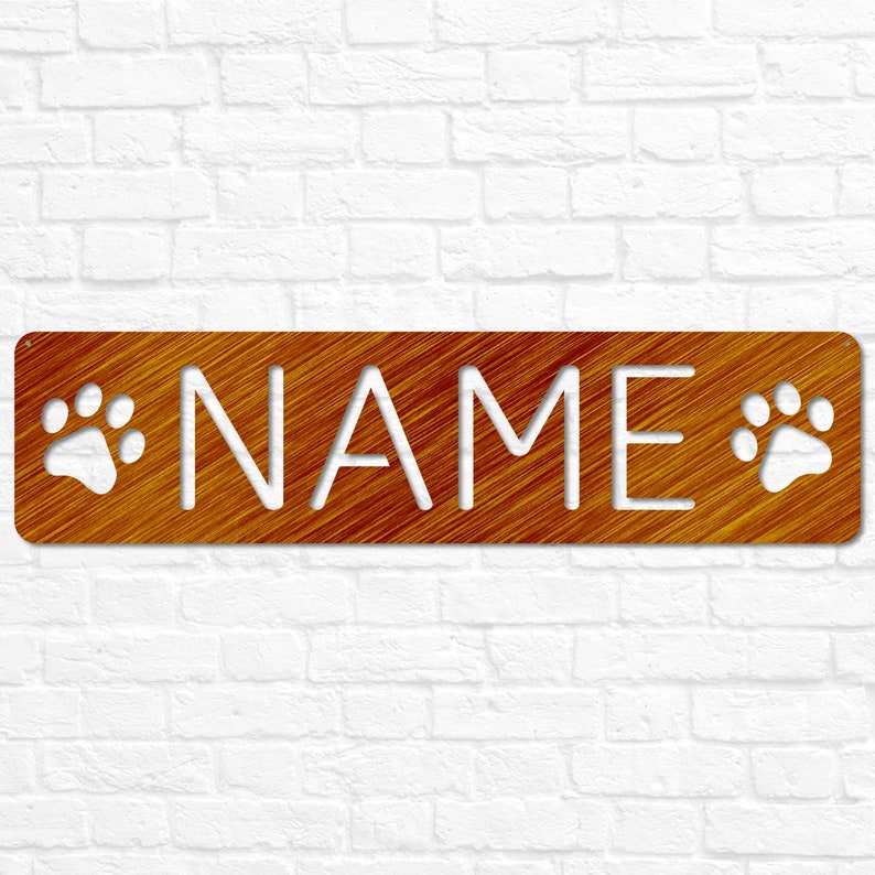 May include: A brown wooden sign with the word "NAME" cut out in white. The sign has two white paw prints on either side of the word.