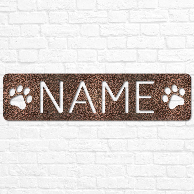 May include: A copper-colored metal sign with the word "NAME" cut out in white. The sign has two white paw prints on either side of the word.