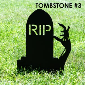 May include: Black tombstone silhouette with the letters "RIP" cut out, and a zombie hand reaching out. The tombstone is set in green grass, with the text "TOMBSTONE #3" at the top.