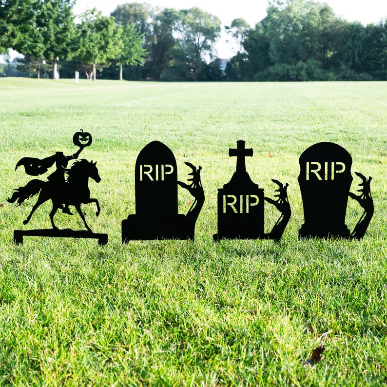 May include: Black metal Halloween yard decorations. Includes a silhouette of the Headless Horseman riding a horse, and three tombstones with "RIP" text. The tombstones have zombie hands reaching out. Perfect for Halloween.