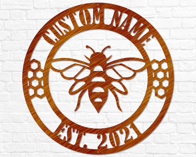 May include: A round, brown metal sign with a bee and honeycomb design. The sign says "Custom Name Est. 2021".
