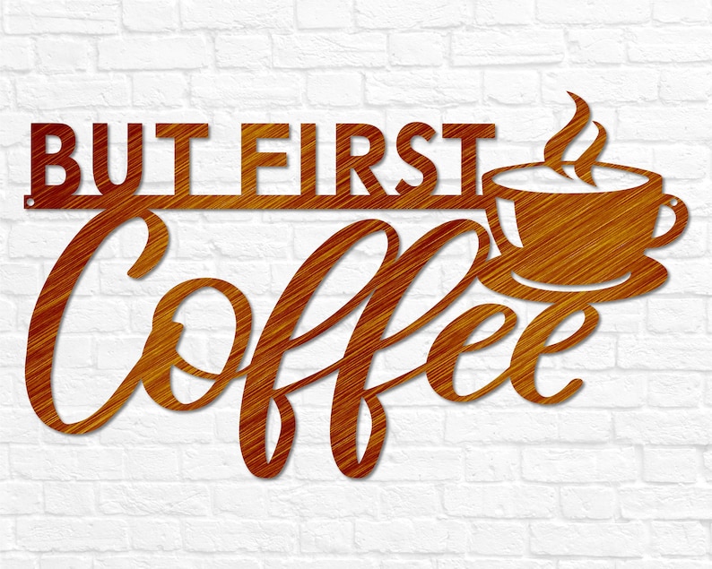 May include: A brown metal sign with the text "But First Coffee" in a stylized font. A coffee cup with steam rising from it is depicted to the right of the text.