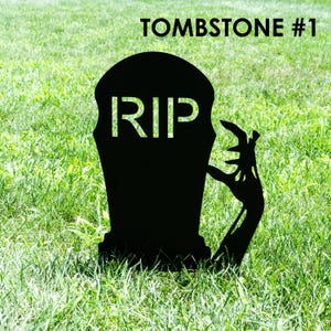May include: Black metal tombstone silhouette with the word "RIP" cut out. A zombie hand reaches out from the side. The text "TOMBSTONE #1" is at the top. The tombstone is set in green grass.
