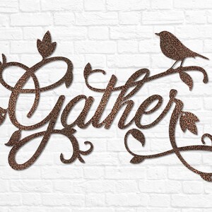 May include: A metal wall decoration featuring the word "Gather" in a decorative script font. The word is surrounded by stylised leaves and vines. A small bird is perched on a branch at the top of the decoration.