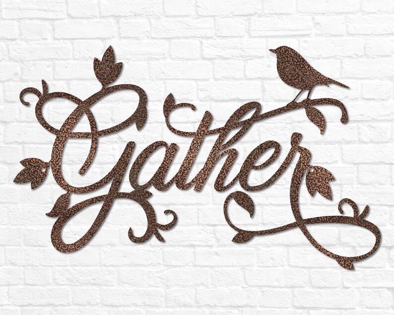 May include: A metal wall decoration featuring the word "Gather" in a decorative script font. The word is surrounded by stylised leaves and vines. A small bird is perched on a branch at the top of the decoration.