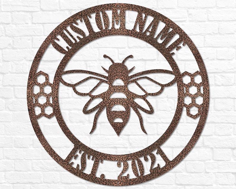 May include: A circular metal sign with a rustic brown finish. The sign features a bee with honeycomb designs and the text "CUSTOM NAME EST. 2023".