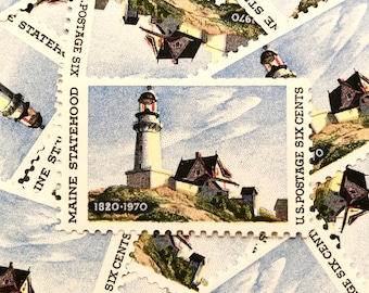 May include: A collection of vintage US postage stamps featuring a lighthouse and a house on a rocky shore. The stamps are from the Maine Statehood series and were issued in 1970. The stamps are in excellent condition and would be a great addition to any stamp collection.