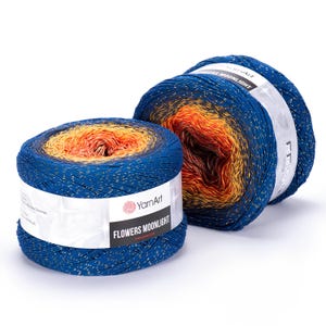 May include: Two skeins of YarnArt Flowers Moonlight yarn. The yarn is a gradient of blue, orange, and yellow with gold flecks. The label reads "Flowers Moonlight". The yarn is ideal for knitting or crocheting projects.