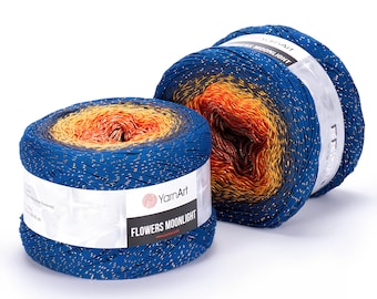 May include: Two skeins of YarnArt Flowers Moonlight yarn. The yarn is a gradient of blue, orange, and yellow with gold flecks. The label reads "Flowers Moonlight". The yarn is ideal for knitting or crocheting projects.