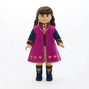 May include: A doll wearing a purple and gold dress with a blue vest and matching boots. The doll has brown hair in braids and blue eyes.