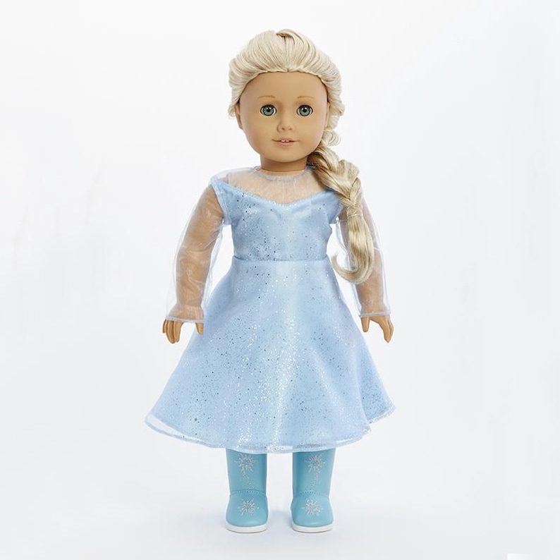May include: A doll wearing a light blue dress with a sparkly bodice and sheer sleeves. The doll has blonde hair in a braid and is wearing light blue boots with snowflake designs.