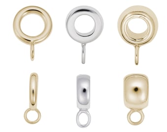 Può includere: Sei diversi anelli di salto in oro e argento con un anello in basso. Gli anelli di salto sono rotondi e hanno una finitura liscia.