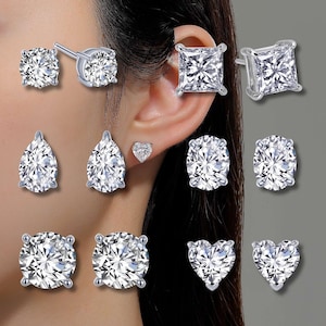 May include: A set of ten silver earrings with clear cubic zirconia stones. The earrings are in various shapes, including round, square, pear, and heart.