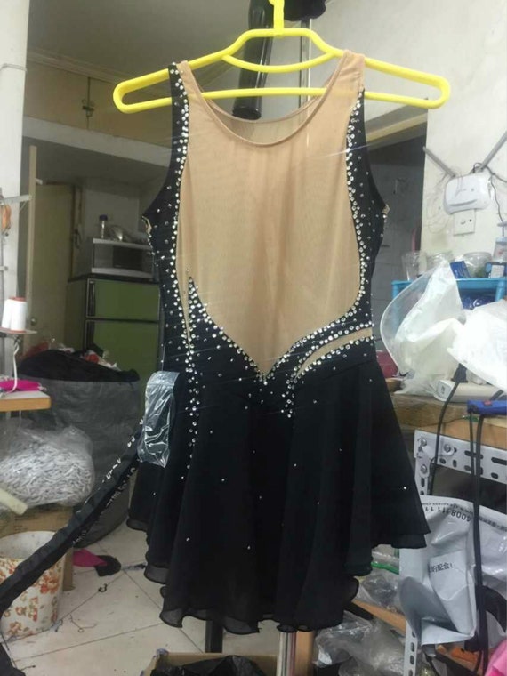 black figure skating dress Here's another dress from the summer that's never been see before This sassy black and gold faux 2 piece set was designed for L's Rhythm Nation solo. She really brought the attitude