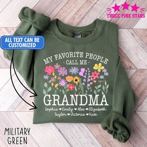Może przedstawiać: Zielona wojskowa bluza z napisem "MY FAVORITE PEOPLE - CALL ME - GRANDMA" i kwiatowym wzorem. Poniżej wymienione są imiona: Sophia, Emily, Alex, Elizabeth, Taylor, Victoria i Kate. Tekst "ALL TEXT CAN BE CUSTOMIZED" znajduje się po lewej stronie.