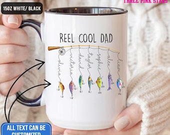 May include: White 15oz ceramic mug with a black interior and handle. The mug features the text "REEL COOL DAD" with personalized names hanging from a fishing line. The text "ALL TEXT CAN BE CUSTOMIZED" is also visible.