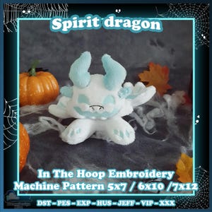 May include: A white and light blue plush dragon toy with horns and embroidered details. The image includes the text Spirit dragon, In The Hoop Embroidery Machine Pattern 5x7 / 6x10 / 7x12, and file formats DST, PES, EXP, HUS, JEFF, VIP, XXX.