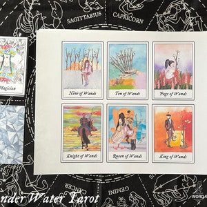 May include: A set of nine tarot cards featuring watercolor illustrations of the Major Arcana and the suit of Wands. The cards are printed on white cardstock and have a white border.