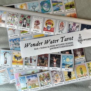 May include: A set of Wonder Water Tarot cards with a white background and colorful illustrations. The cards are arranged in rows and include the names of the cards, such as "The Fool", "The Magician", and "The Empress". The text "Wonder Water Tarot" is printed on a white sticker with a black dagger symbol.
