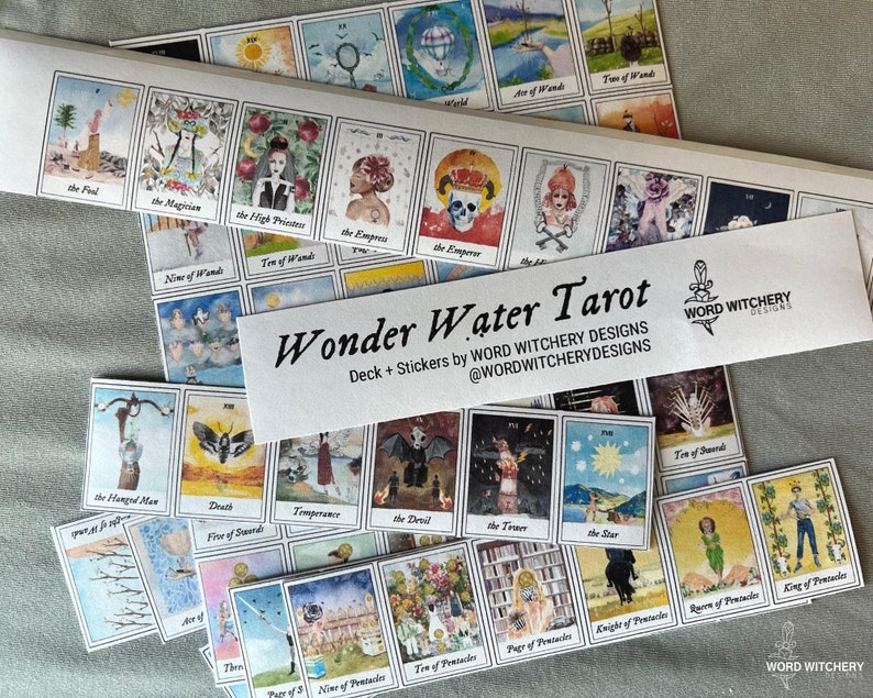 May include: A set of Wonder Water Tarot cards with a white background and colorful illustrations. The cards are arranged in rows and include the names of the cards, such as "The Fool", "The Magician", and "The Empress". The text "Wonder Water Tarot" is printed on a white sticker with a black dagger symbol.