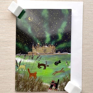 Carte de voeux chats en patinage d'aurores boréales (4 x 6 pouces) avec enveloppe - scène d'hiver fantaisiste, intérieur vierge pour des messages personnalisés
