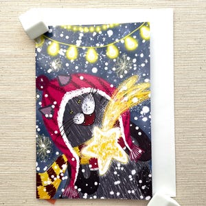 Tarjeta de felicitación festiva con gato negro y estrella fugaz (4" x 6") con sobre: acogedora escena invernal, interior en blanco para expresar deseos navideños