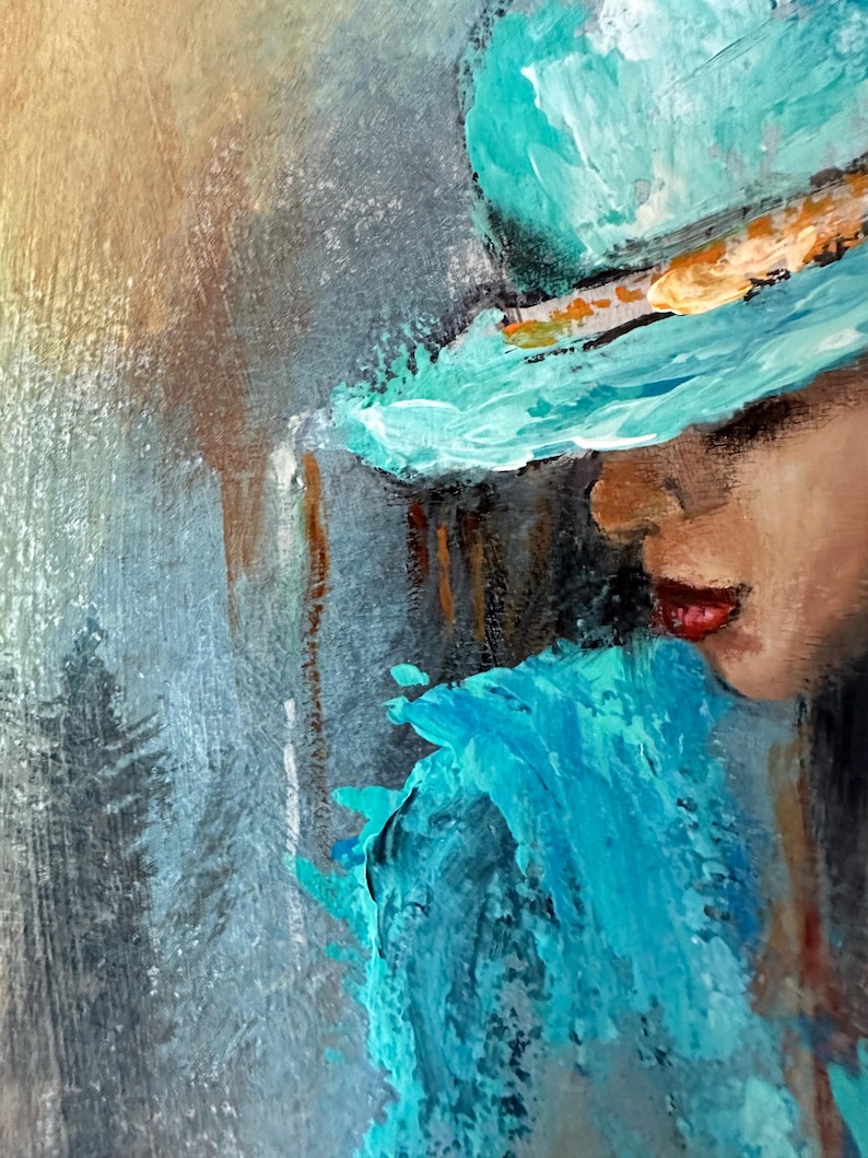 May include: A painting of a woman wearing a teal blue hat with a gold band. The woman's face is partially obscured by the hat, and she is looking down. The background is a blurry, abstract painting of teal blue and gray.