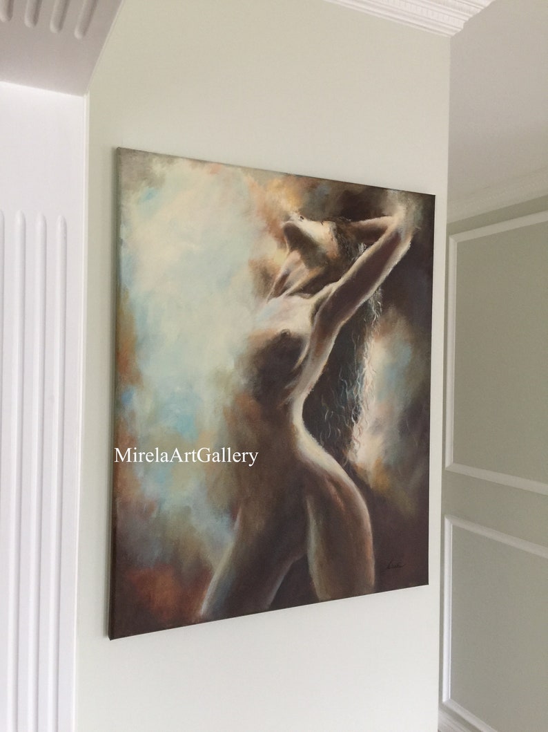 May include: A painting of a nude woman with long hair, painted in shades of brown, blue, and white. The woman is posed with her arms raised above her head, and her body is illuminated by a soft light. The painting is signed in the lower right corner.