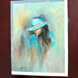 May include: A painting of a woman wearing a blue hat and a blue shirt. The background is a soft, abstract blend of colors.