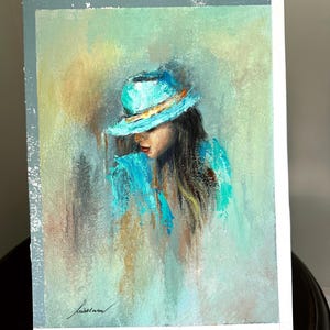 May include: A painting of a woman with long brown hair wearing a turquoise hat and a turquoise shirt. The background is a soft green and blue.