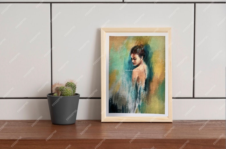 May include: A framed painting of a woman with a blue background. The woman is wearing a white dress and has her back to the viewer. The painting is in a wooden frame.