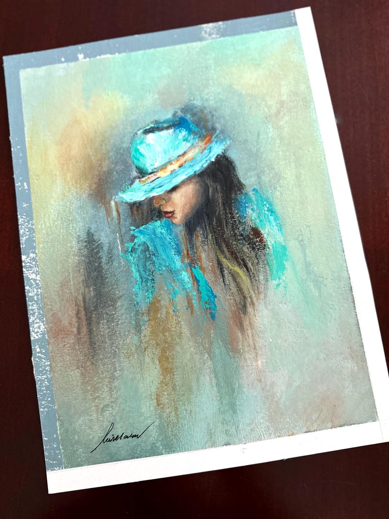 May include: A painting of a person wearing a blue hat and a blue shirt. The person is looking down and their face is partially obscured by the hat. The background is a light blue and green.