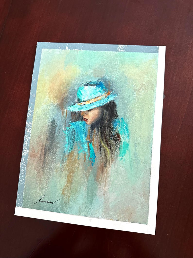 May include: A painting of a woman wearing a turquoise hat with a gold band. The woman's hair is long and dark, and she is looking down. The background is a soft, muted green and yellow.