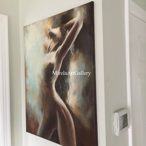 May include: A painting of a nude woman with long hair, standing with her arms raised above her head. The painting is done in a soft, muted palette of browns, blues, and whites. The background is a blurry, abstract design. The painting is signed in the lower right corner.