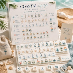 May include: A Coastal Lifestyle Mahjong set featuring a white box with tile illustrations, a beige drawstring bag, and a quick start guide. The set includes 152 tiles with coastal-themed graphics like shells, palm trees, and waves, plus blank tiles.