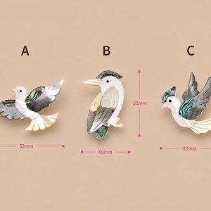 May include: Three decorative bird brooches. Brooch A is 5.8 cm wide and 3.3 cm tall. Brooch B is 4 cm wide and 5.2 cm tall. Brooch C is 4.3 cm wide and 4.8 cm tall. Each brooch features iridescent and white shell accents.