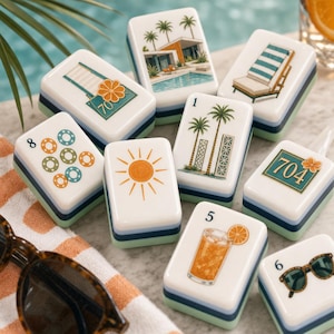 May include: A collection of white rectangular mahjong tiles featuring colorful illustrations of palm trees, a swimming pool, a sun, a drink, sunglasses, and the numbers 1, 5, 6, 8, and the text 70 and 704 with orange flower accents.