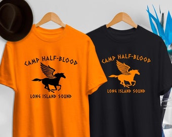 May include: Two t-shirts, one orange and one black, each with the text "CAMP HALF-BLOOD LONG ISLAND SOUND" above a winged horse graphic. The orange shirt has a black graphic, while the black shirt has an orange graphic.