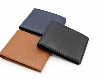 May include: Three leather wallets in different colors: brown, black, and blue. The wallets are folded and arranged on a white surface.