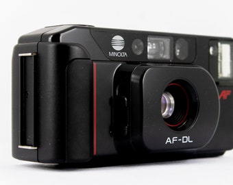 Minolta AF-DL 35mm Filmkamera komplett mit umschaltbarem 35mm oder 50mm Doppelobjektiv, sehr guter Zustand mit Koffer beides in OVP.
