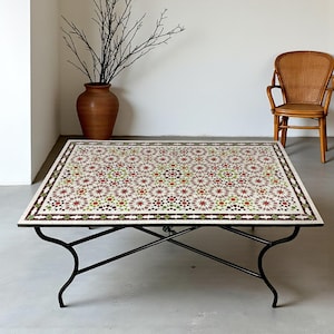 May include: A rectangular coffee table with a mosaic tile top featuring a geometric pattern in shades of red, green, and brown. The table has a black metal base. The table is approximately 48 inches long and 30 inches wide.