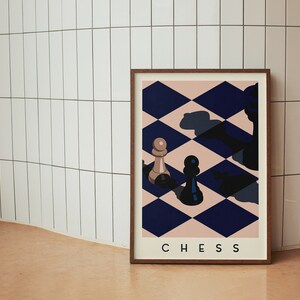May include: A framed art print featuring a chess-themed design. The artwork displays a chessboard pattern in navy blue and blush pink, with chess pieces. The word "CHESS" is printed at the bottom of the print.