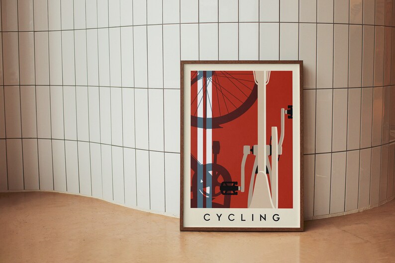 May include: Framed art print featuring a minimalist bicycle design in red, white, and blue. The word "CYCLING" is printed in a sans-serif font at the bottom. The artwork is displayed against a white tiled wall.