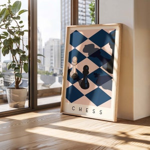 May include: A framed art print featuring a chess-themed design. The artwork displays a geometric pattern of blue and pink diamonds with chess pieces. The word "CHESS" is printed in white at the bottom. The frame is made of light-colored wood.