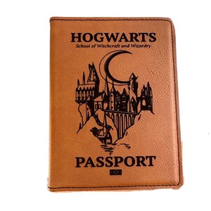 May include: A brown leather passport holder with the words "HOGWARTS School of Witchcraft and Wizardry" and "PASSPORT" printed on the front. The holder features a black and white illustration of Hogwarts castle.