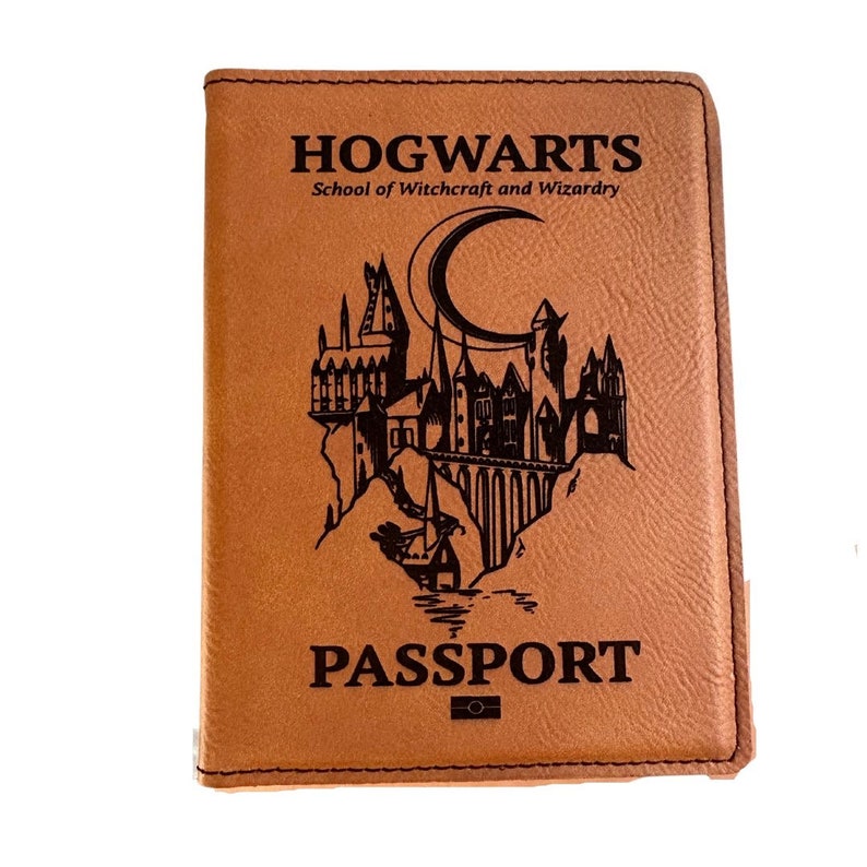 May include: A brown leather passport holder with the words "HOGWARTS School of Witchcraft and Wizardry" and "PASSPORT" printed on the front. The holder features a black and white illustration of Hogwarts castle.